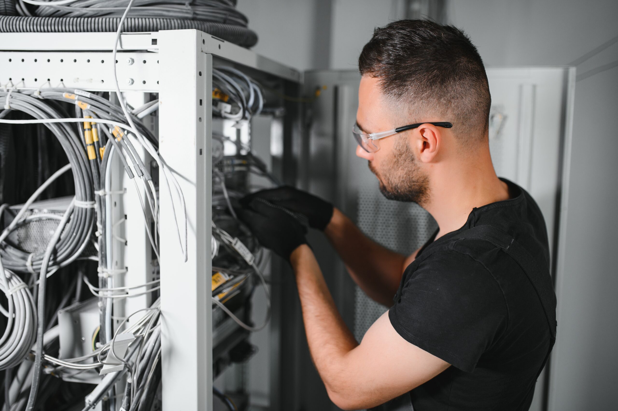 Skilled electrical technicians inspecting and maintaining an electrical system beyond routine repairs
