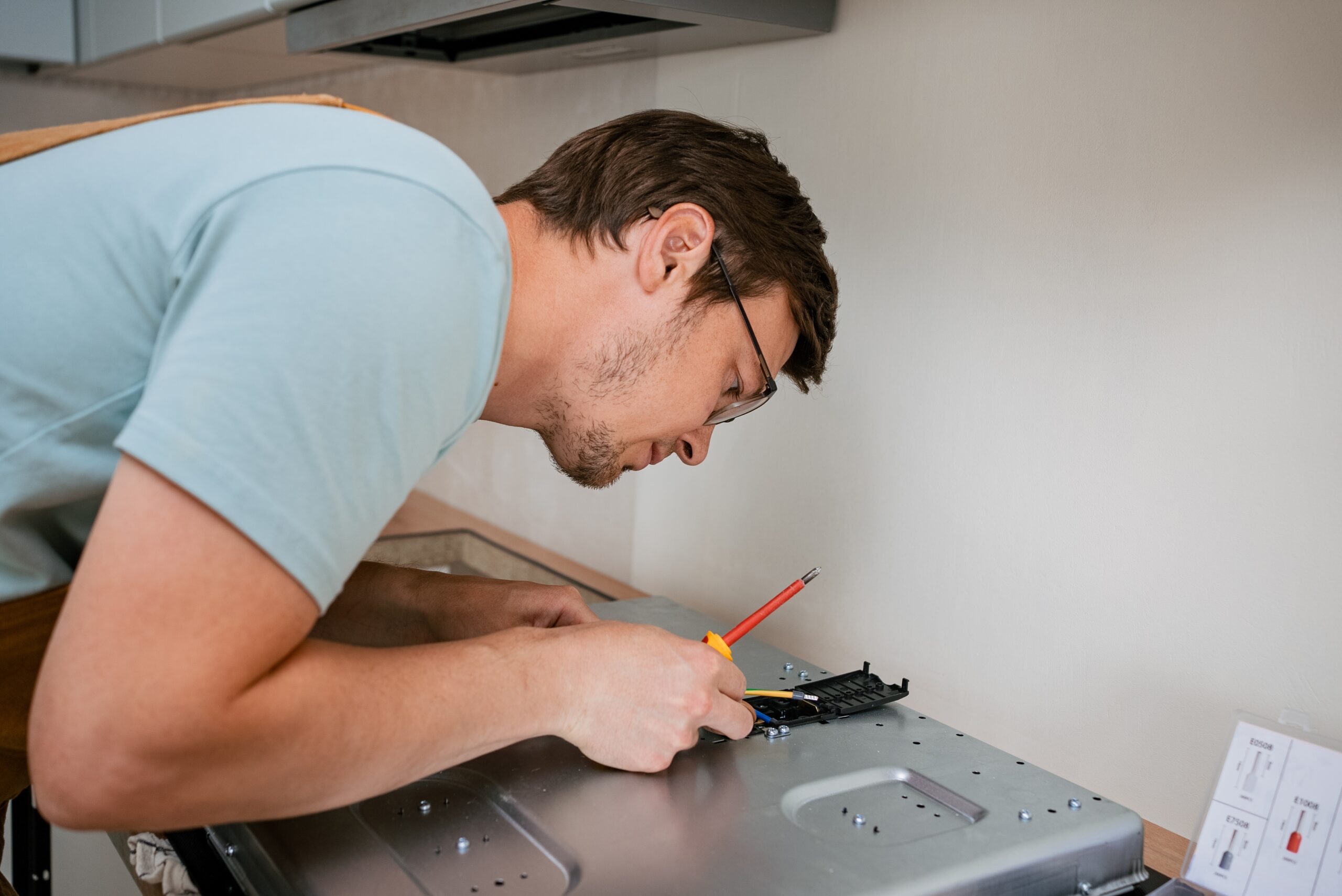 Professional electricians performing a full system inspection of a residential electrical panel and wiring
